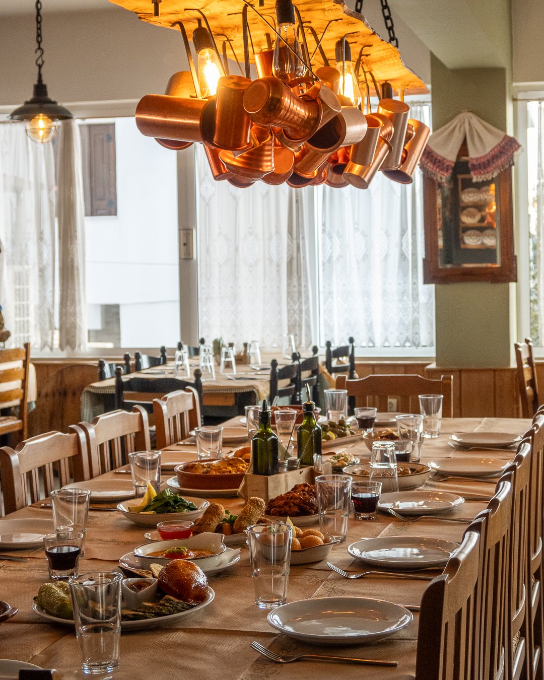 The dining room and copper lighting at Yiarenis